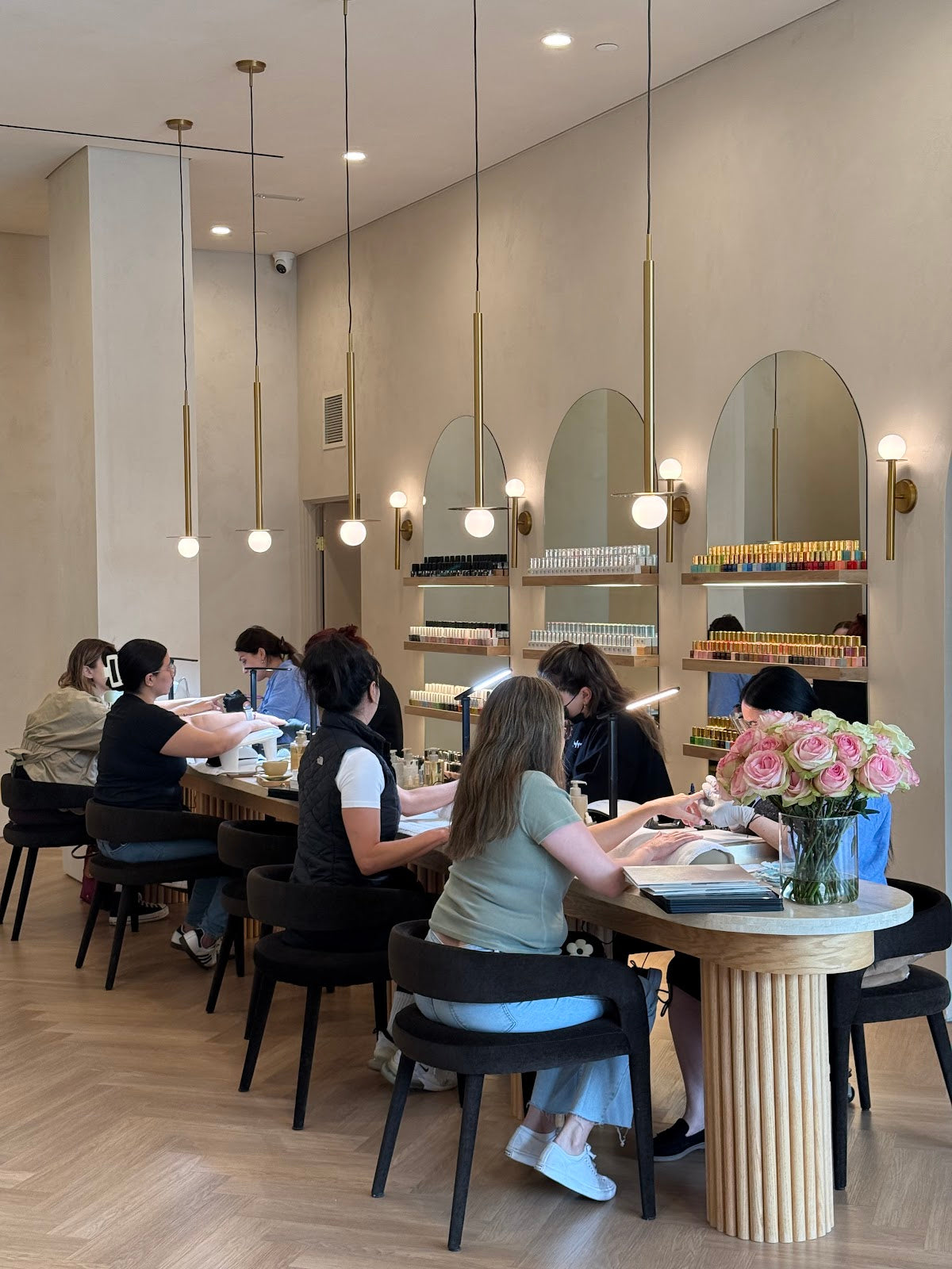 Nail artists providing manicure services at All Six